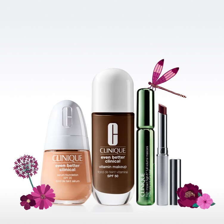 foundation, mascara, and honey lipstick aligned with flowers around 